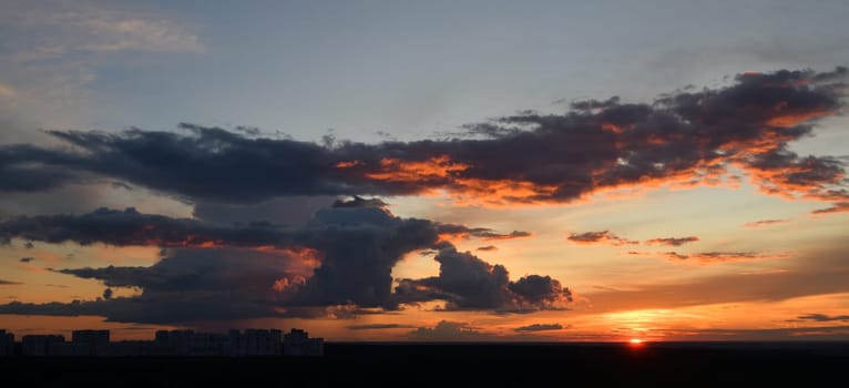Beautiful panoramic sunset with a city on the horizon