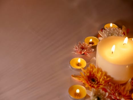 Celebration of Diwali or Deepavali holiday in India with candles and flowers in the evening at night close-up. Hindus celebrate the festival of lights,