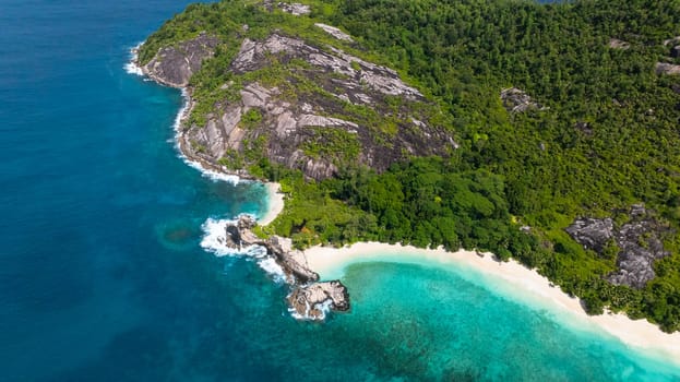 A coastline featuring white sandy beaches, turquoise waters, and rocky hills. Therese. Seychelles, Mahe.