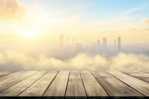 A symmetrical wooden platform offers a striking view of a futuristic city skyline at sunset. The scene is enveloped in soft clouds and warm light, creating tranquility.
