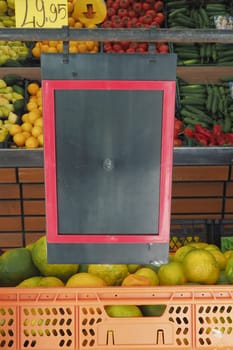 Colorful fruits and vegetables are neatly arranged for sale.