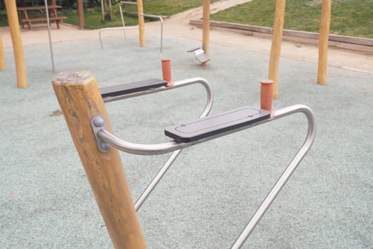 A fitness station is present in a park for exercise enthusiasts to use.