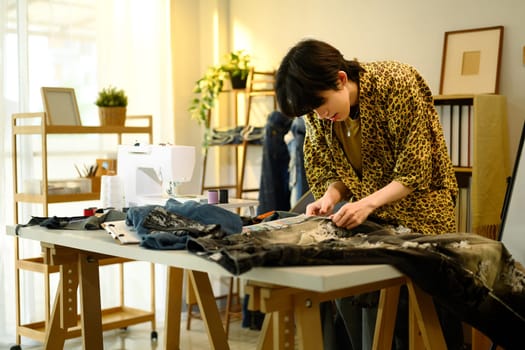 Creative fashion entrepreneur working on a handmade garment in a stylish workspace.