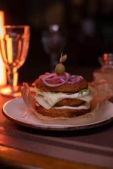 Juicy mouth-watering fatty burger made from grated potatoes and meat on the table in the restaurant.