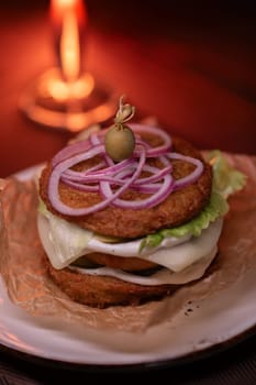 Juicy mouth-watering fatty burger made from grated potatoes and meat on the table in the restaurant.