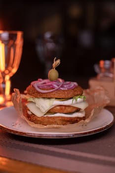 Juicy mouth-watering fatty burger made from grated potatoes and meat on the table in the restaurant.