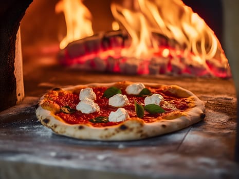 A freshly prepared pizza with tomato sauce, mozzarella, and basil bakes inside a traditional wood-fired oven. Flames and glowing embers create a warm and rustic atmosphere.