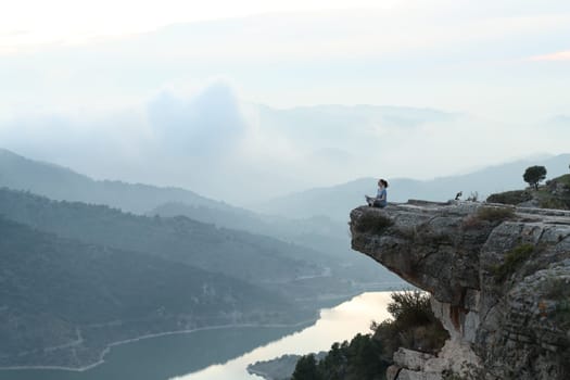 Yogi doing yoga in a beautiful cliff in nature
