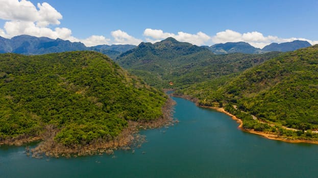 A beautiful lake among the mountains with a green forest. Kalu Ganga Reservoir, Sri Lanka.
