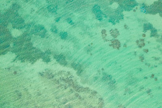 Turquoise lagoon surface on atoll and coral reef, copy space for text.