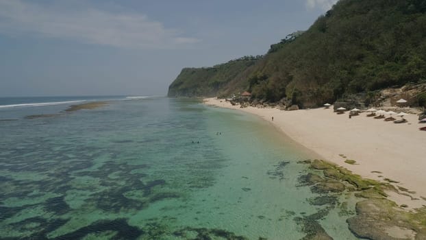 Aerial view coast with sandy tropical beach. seascape ocean surf and tropical beach large waves turquoise water crushing on beach Melasti, Bali,Indonesia. Travel concept.