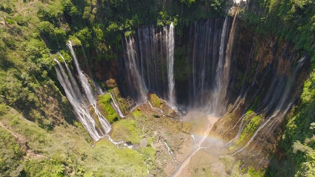 beautiful waterfall Coban Sewu in tropical forest, Java Indonesia. aerial view tumpak sewu waterfall in rainforest