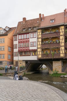 Erfurt, Germany – September 30, 2024: The medieval Kramerbrucke in Erfurt with the river Gera and some tourists