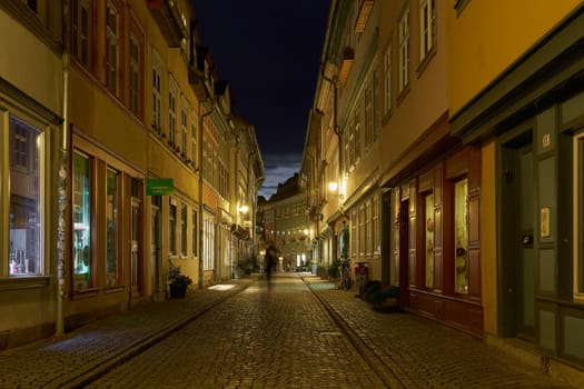 Erfurt, Germany – October 01, 2024: Erfurt, Germany – October 01, 2024: The Kramerbrucke in Erfurt in Germany with some stores in historic houses on both sides of the bridge at night