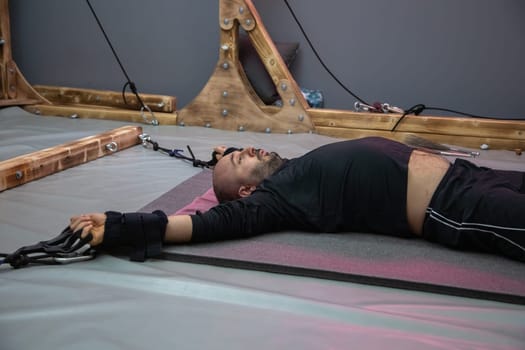 Caucasian man lying on a table during an alternative therapy session, suggesting relaxation and healing