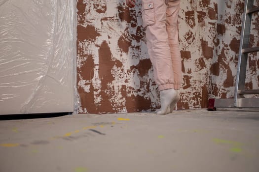 Capturing the unique essence of a renovation with a professional painter actively working amidst textured walls