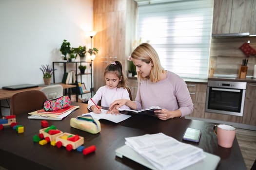 Engaging study session with mother helping daughter with schoolwork.