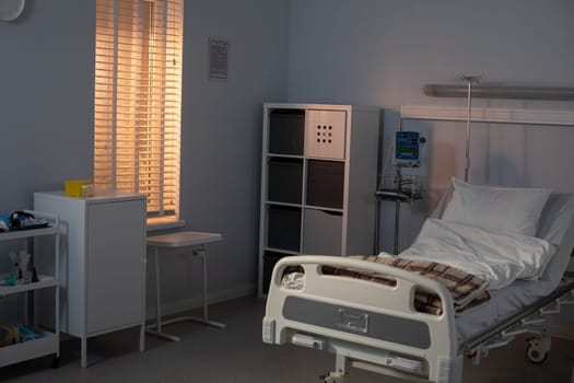 A serene hospital room with a comfy bed, essential medical equipment, and gentle sunlight streaming in