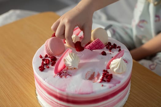 A closeup view of a delightful pink cake, beautifully topped with delicate decorations, ideal for any celebrations