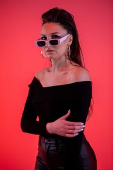 A chic and fashionable woman confidently poses in her trendy sunglasses, perfectly showcasing modern fashion vibes