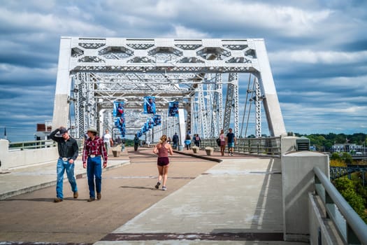 October 13, 2023, Nashville, TN: People strolling across John Seigenthaler Pedestrian Bridge in downtown Nashville