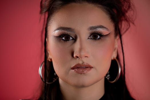 This striking and enchanting portrait features glamorous makeup along with a vibrant and colorful background