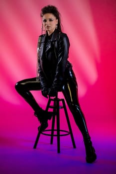 A striking and captivating image of a highly confident model striking a pose in urban fashion against vibrant lighting