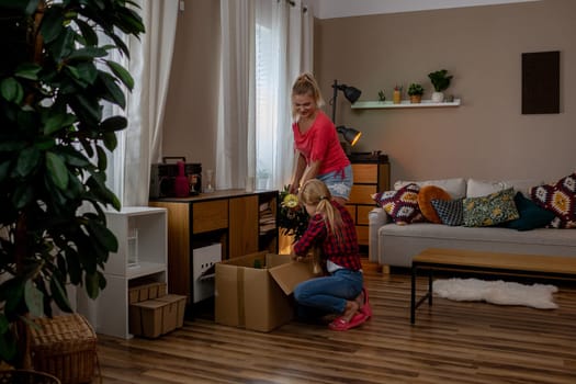 A warm and inviting scene featuring family teamwork as they unpack boxes in a cozy living room setting