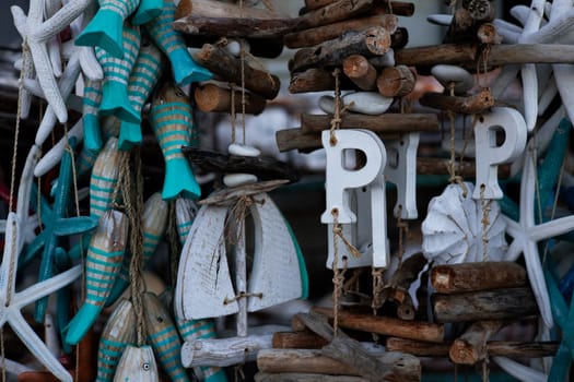 Coastal themed decorations with driftwood, fish, and starfish motifs.