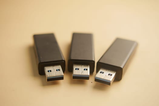 Three USB flash drives arranged in a row display their design.