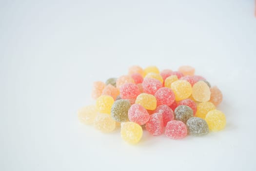 Assorted gummy candies in various colors piled together on a surface.