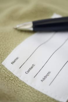 Blank contact form displayed with a pen ready for filling out.