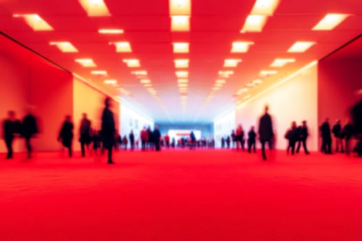 Large exhibition hall red carpeted floor high ceiling Abstract blur people..