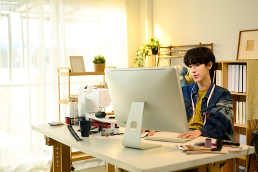 Creative entrepreneur planning new clothing designs in a stylish studio.