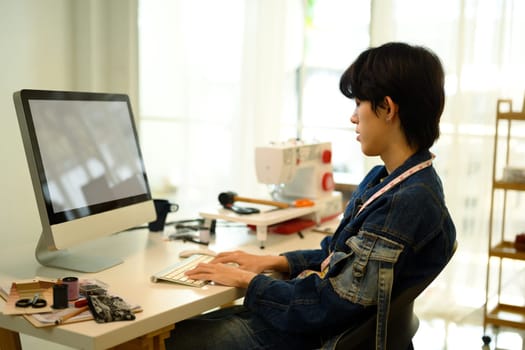 Young designer planning new clothing designs in a stylish studio.