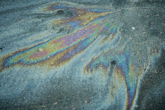 Vivid oil slick producing a beautiful, swirling abstract pattern that captures attention.