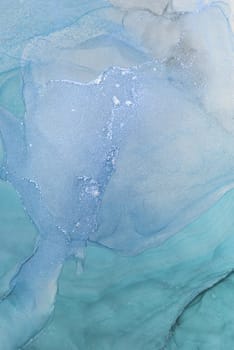 This artwork showcases a captivating alcohol ink abstract composition featuring flowing blue hues and soft textures. The delicate interplay of colors creates a tranquil atmosphere.