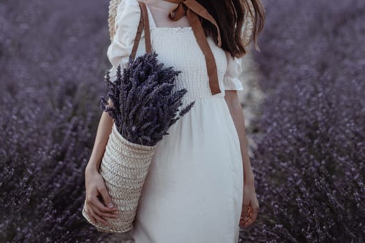 Woman holding wicker basket with a lavender in the field