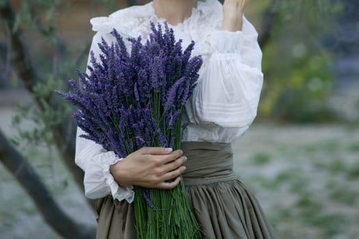 Woman holding bouquet with a lavender in the field in Provence France