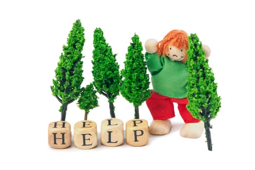 Letter cubes with the word HELP and a small toy figure with four model trees on a white background.