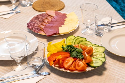 Shot of the table set up with assorted cut fresh vegetables, cold cuts, olives