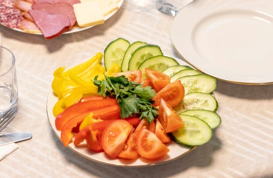Shot of the table set up with assorted cut fresh vegetables, cold cuts, olives