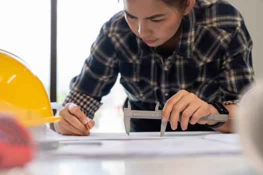 architect working with blueprints, engineer inspection in workplace for architectural plan, sketching a construction project.