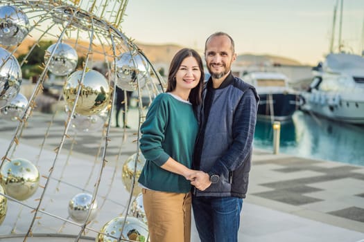 Couple in love tourists enjoying the views of Architecture and luxury yachts in Lustica Bay, Montenegro. Travel around Montenegro concept. Go Everywhere.