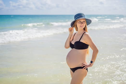 Radiant pregnant woman in a swimsuit, amid the stunning backdrop of a turquoise sea. Serene beauty of maternity by the shore.