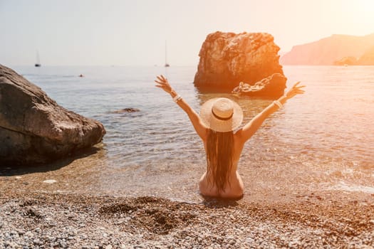 Woman travel sea. Happy tourist taking picture outdoors for memories. Woman traveler looks at the edge of the cliff on the sea bay of mountains, sharing travel adventure journey.