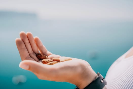 Unrecognizable caucasian woman eating young milky almond nuts. Healthy vegan food