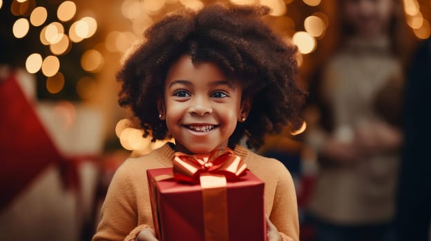 Little cute, African American child holding a gift box with a red ribbon and giving gifts at a holiday event, New Year and Christmas.