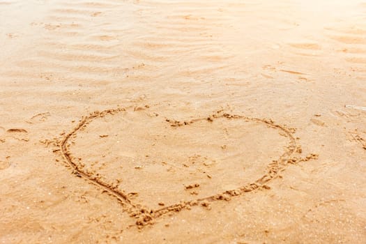 a painted heart on the sand on the beach