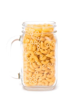 Uncooked Chifferi Rigati Pasta in Glass Jar Isolated on White Background. Fat and Unhealthy Food. Classic Dry Macaroni. Italian Culture and Cuisine. Raw Pasta - Isolation